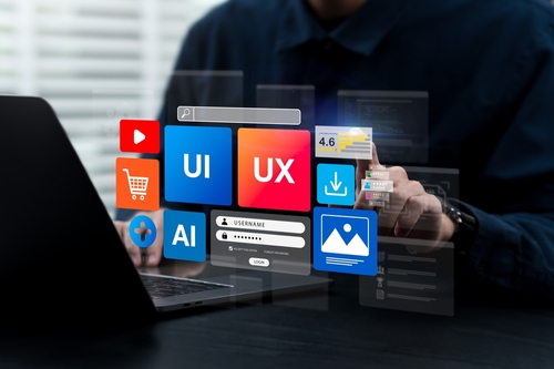 Designer working on UI/UX interface with colorful design elements including shopping cart, AI, and image icons
