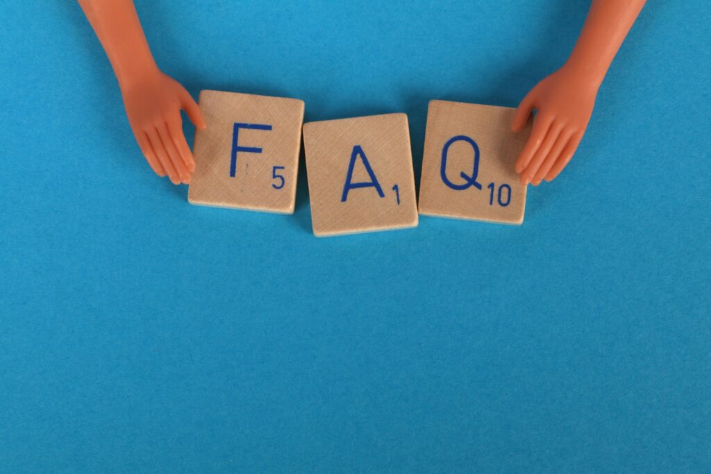 Hands arranging FAQ tiles for LeverEdge AI Sales Coach